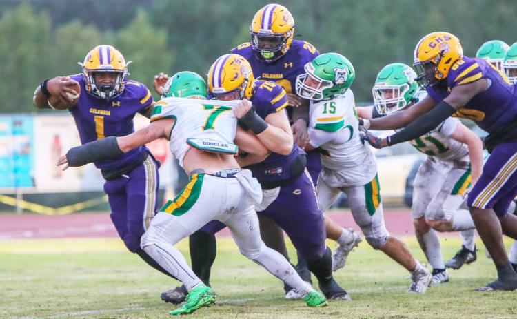 Columbia quarterback Zamarion Jones scrambles up field as center Zackery Grimes blocks Suwannee linebacker Jace Moran during Friday’s game. (BRENT KUYKENDALL/Lake City Reporter)