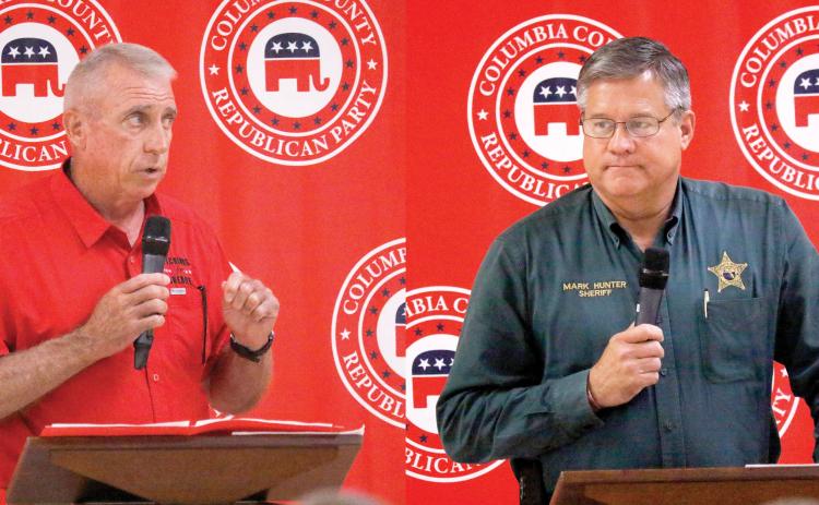 Wallace Kitchings (left) and Mark Hunter, candidates for Columbia County sheriff, speak to voters on Thursday at the Columbia County Republican Party's political rally at the Florida Gateway Fairgrounds. (Photos by JAMIE WACHTER/Lake City Reporter)