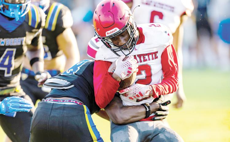 Lafayette receiver Jordan Murphy takes a hit from a Newberry defender after a catch in their Preseason Classic on Aug. 15. (JACK HOWDESHELL/Lake City Reporter)
