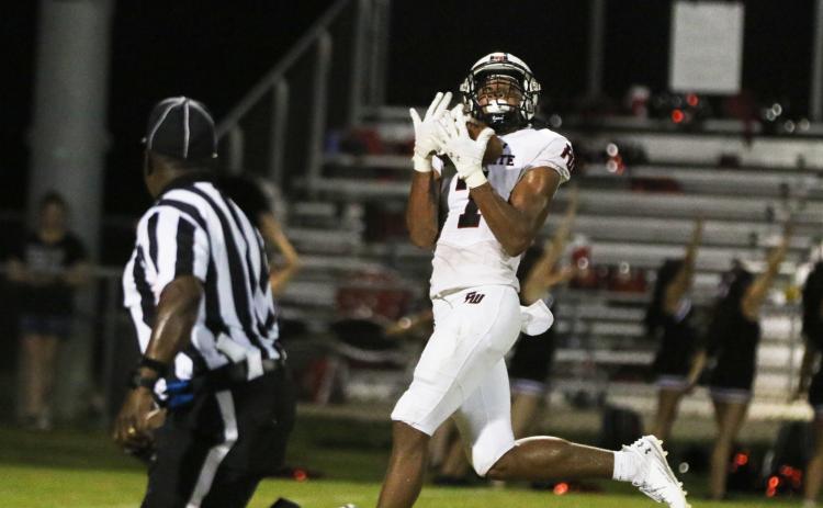 Fort White receiver Tafari Moe catches a long scoring pass against Belleview on Friday night. (MORGAN MCMULLEN/Lake City Reporter)