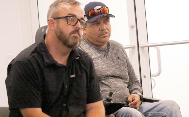 Dustin Busscher (left) and Abel Caballero listen as the Board of Adjustments discusses whether to grant a special exception for Caballero to operate a welding shop on his property in western Columbia County. The board did grant the exception. (JAMIE WACHTER/Lake City Reporter)