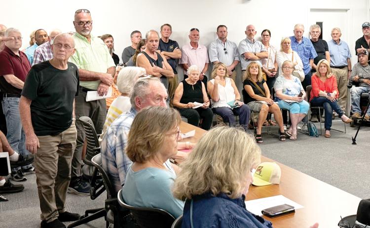 A crowd of approximately 100 people crammed into the Tourist Development Council conference room Thursday, leading to tabling the discussion on a housing project. (JAMIE WACHTER/Lake City Reporter)