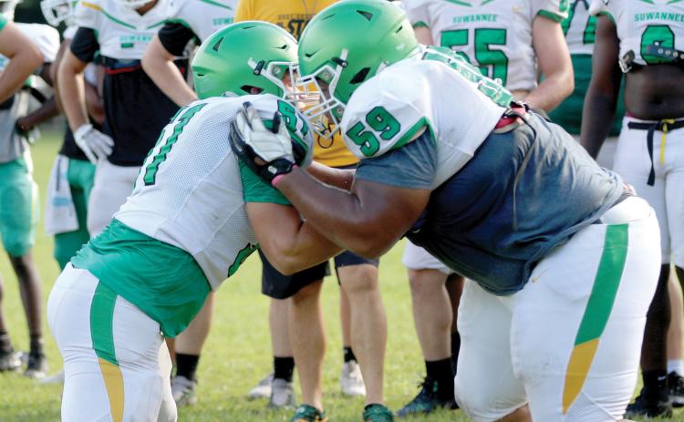 Suwannee offensive lineman Brody Bean and defensive lineman Will Brown perform a run-blocking drill during practice on Aug. 3. (JAMIE WACHTER/Lake City Reporter)