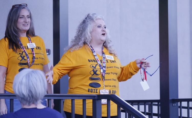 Tomi Brown, Columbia County’s supervisor of elections, addresses the crowd outside her office Tuesday night about the state’s website crash. (JAMIE WACHTER/Lake City Reporter)