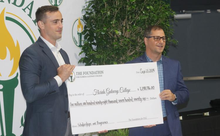 Lee Pinchouck, the executive director of The Foundation for Florida Gateway College (right), and Noah Walker, the foundation board’s president presented a check to the college for nearly $1.2 million on Wednesday for scholarships and program enhancement. (TONY BRITT/Lake City Reporter)