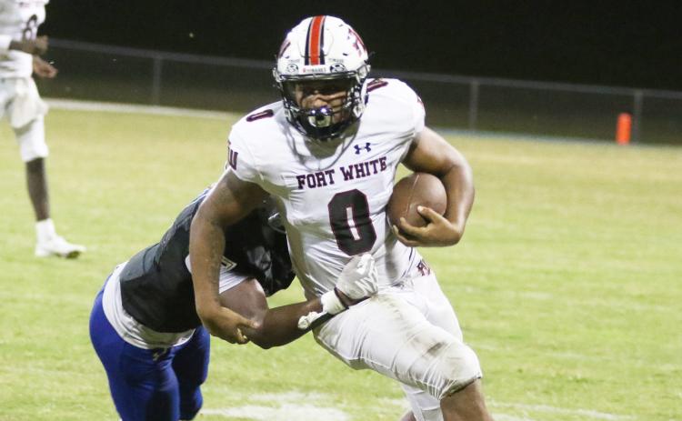 Fort White running back Lecosta Byrd shakes off a tackle against Belleview last Friday. (MORGAN MCMULLEN/Lake City Reporter)