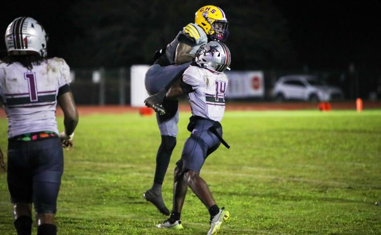Columbia receiver Kyren Caldwell gets wrapped up by Madison County defensive back Sean Williams following a catch on Friday. (BRENT KUYKENDALL/Lake City Reporter)