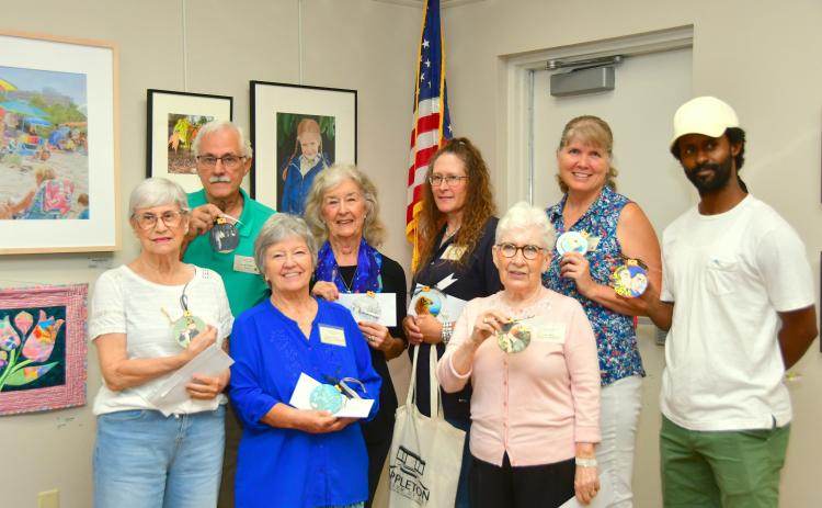 The Live Oak Artists Guild honored the winners in the 26th annual Autumn Artfest during a reception Sept. 7 at the Suwannee River Regional Library branch in Live Oak. The winners in the fine arts exhibition included, front row, Judith Adams (front row, from left), Glinda Pennock, Anda Chance; back row, Rob Wolfe, Christie Stanton, Renee Shiska and Sharon Hester. Jason Holland (back row, right) was the subject of Connor Billups’ honorable mention drawing. (ROB WOLFE/Special to the Reporter)