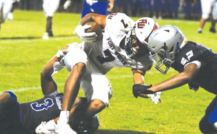 Fort White receiver Tafari Moe gets gang tackled after a catch Friday against Belleview. (MORGAN MCMULLEN/Lake City Reporter)