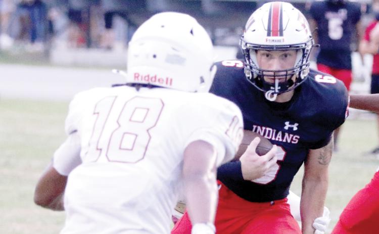 Fort White running back Hayden McCrory eyes a North Marion defender on a run Friday night. (MORGAN MCMULLEN/Lake City Reporter)