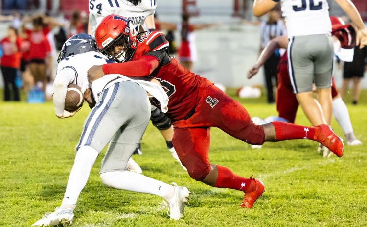 Lafayette’s Zamarion Hawkins wraps up a Brookwood runner last Friday night. (JACK HOWDESHELL/Lake City Reporter)