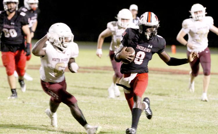 Fort White quarterback Jayden Jackson scrambles against North Marion last Friday night. (MORGAN MCMULLEN/Lake City Reporter)