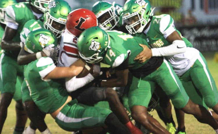 Suwannee’s defense swarms to tackle Lafayette receiver Jordan Murphy last Friday. (PAUL BUCHANAN/Lake City Reporter)