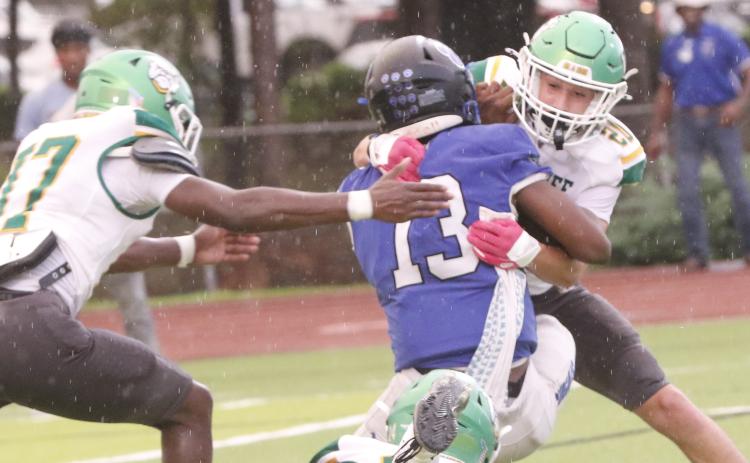 Suwannee safety Kamden Lang tackles Godby quarterback Lazarus Chambers last Friday. (JAMIE WACHTER/Lake City Reporter)