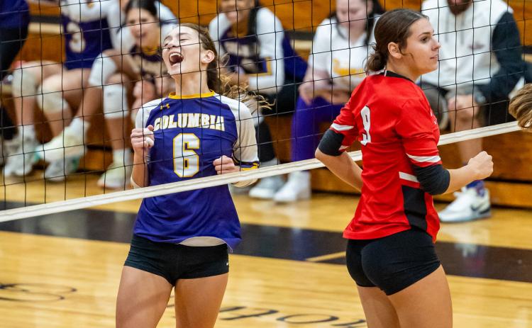Columbia hitter Sinei Wood (6) celebrates a point while Lafayette middle blocker Sophia Kendrick (9) looks on during Tuesday’s match. (JACK HOWDESHELL/Lake City Reporter)