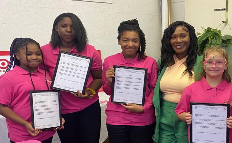 Young Women of Excellence members Lanashia Peterson (from left), Janaisha Peterson, Graciela Gerard, Mrs. Thayla Mullins (Assistant Principal, Lake City Middle School), and Bonnie McKerley pose for a photograph following a recent event. (COURTESY)