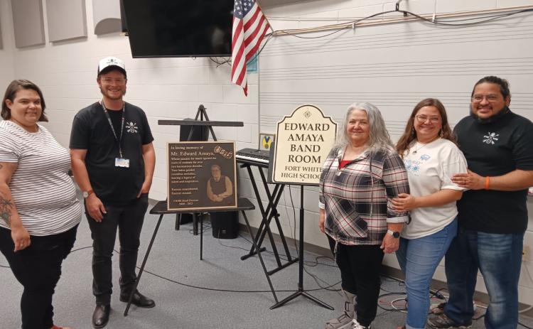 Heather Carraway (from left) stands with David Harris, Fort White High School band director, as they show a plaque and bandroom dedication placard for the late Ed Amaya. Amaya’s family members Peggy Amaya, Miranda Amaya-Firpo and Rafael Amaya-Firpo were also attended the program. (TONY BRITT/Lake City Reporter)