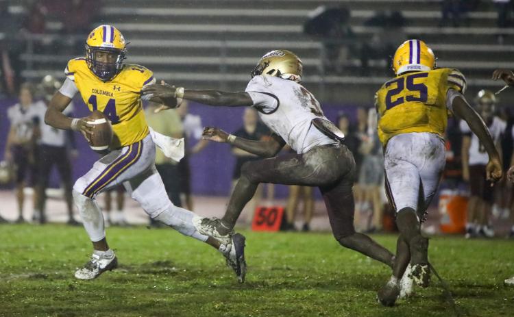 Columbia quarterback Xavier Collins runs away from pressure applied by St. Augustine defensive back Braylon James on Sept. 25. (BRENT KUYKLENDALL/Lake City Reporter)