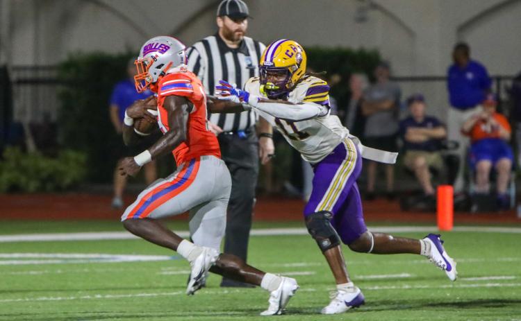 Columbia safety Da’jon Brown tries to wrap up Bolles running back Tyrone Neal on Friday night. (BRENT KUYKENDALL/Lake City Reporter)