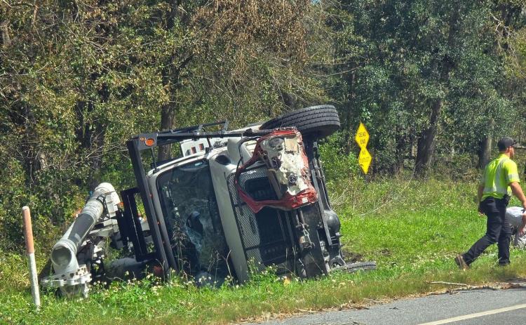Three linemen from North Carolina were injured when their bucket truck overturned as part of a four-vehicle crash northwest of Jasper on Wednesday afternoon. A Jasper man was killed in the crash. (COURTESY)