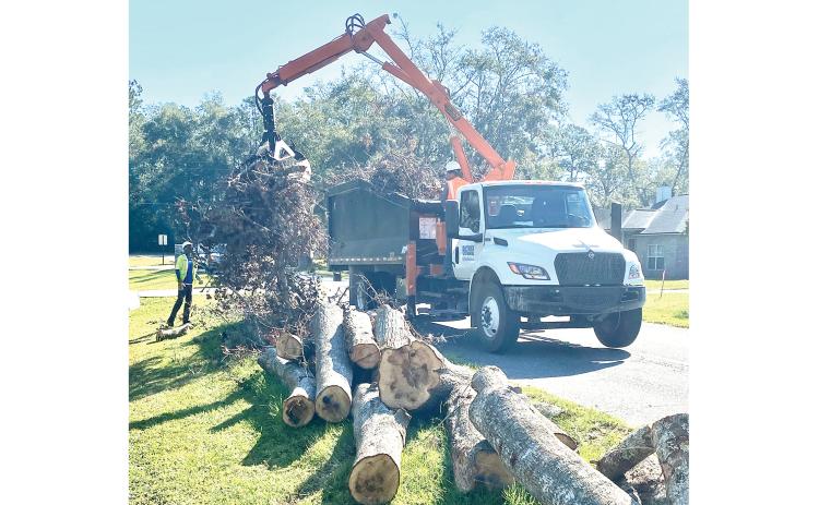 Contractor crews working for Ceres, and contracted with Columbia County to assist with the cleanup of storm debris following Hurricane Helene, pick up stacked debris in the right of way along NW Winding Way on the county’s west side last weekend. (TODD WILSON/Lake City Reporter)