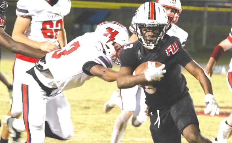 Fort White running back Elijah Gardner runs through the Hilliard defense last Friday. (MORGAN MCMULLEN/Lake City Reporter)