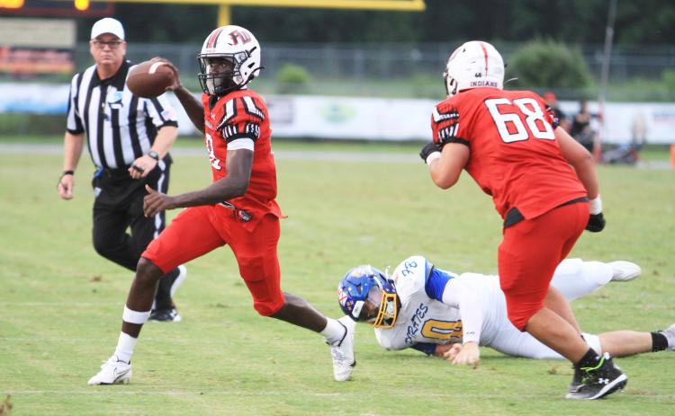 Fort White quarterback Jayden Jackson scrambles away from pressure against Fernandina Beach on Sept. 13. (PAUL BUCHANAN/Lake City Reporter)