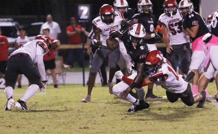 Fort White quarterback Jayden Jackson is tackled by Lafayette’s Joseph Smith on Oct. 4. (JAMIE WACHTER/Lake City Reporter)