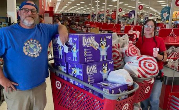 Kids Feeding Kids President John Cole (left) displays the items he got from Target to donate to victims of Hurricane Helene. (COURTESY)