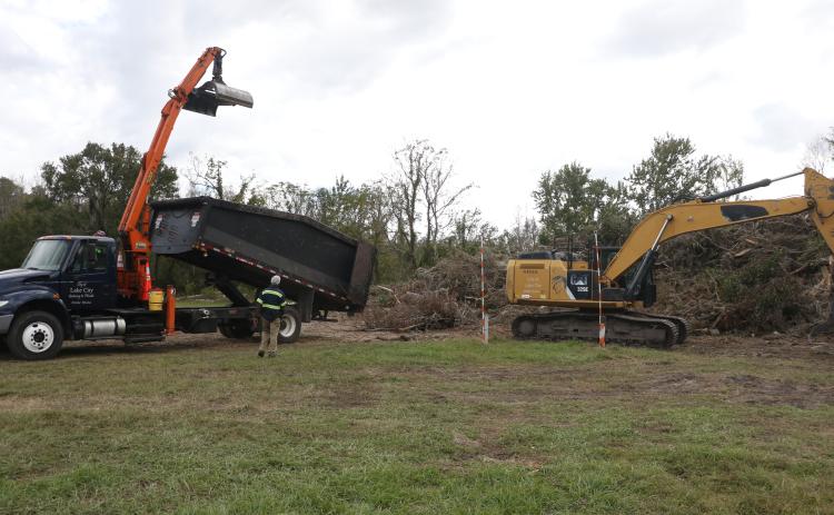 A Lake City Public Works truck gets set to dump debris onto an existing pile at the Public Works lot on NE Gum Swamp Road Friday afternoon. (MORGAN MCMULLEN/Lake City reporter)