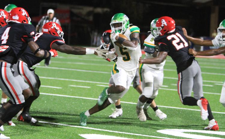 Suwannee receiver MJ Rossin tries to avoid Appling County tacklers as he runs up the field on Sept. 20. (PAUL BUCHANAN/Lake City Reporter)