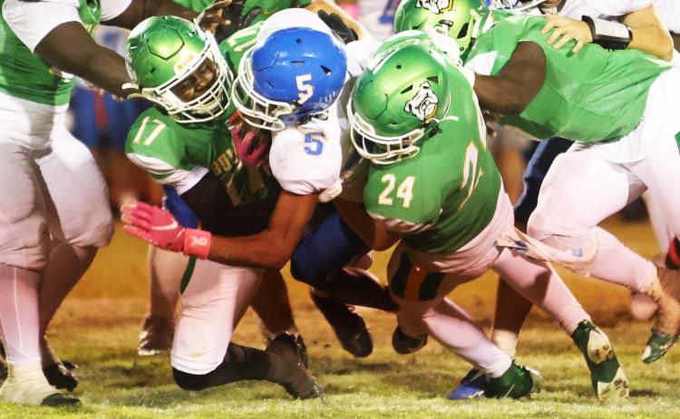 Suwannee linebacker Travis Fead (17) and defensive end Kyler Watson (24) tackle Taylor County running back Dj McCoy last Friday. (PAUL BUCHANAN/Lake City Reporter)
