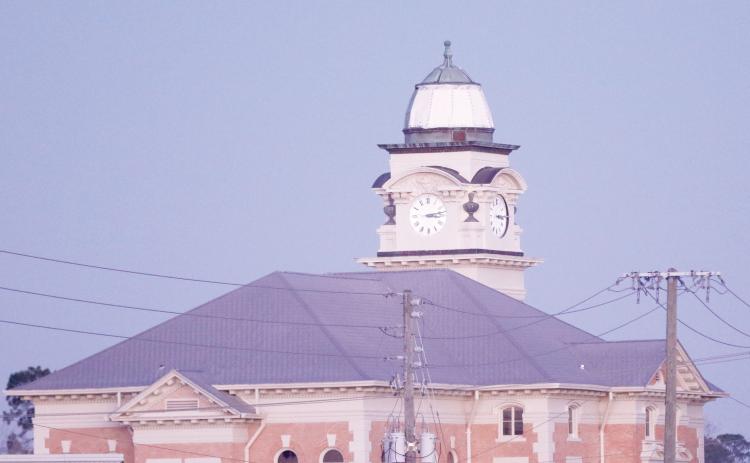The Suwannee County Courthouse was damaged by Hurricane Helene last month with two of the four clock faces knocked out and copper peeled off the dome. Temporary repairs have been done to the dome and the renovation work received a donation this week from the Sons of the American Revolution’s Lake City chapter. (JAMIE WACHTER/Lake City Reporter)