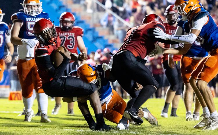 Lafayette quarterback Tywan Williamson fights for extra yardage against Branford on Monday. (JACK HOWDESHELL/Lake City Reporter)