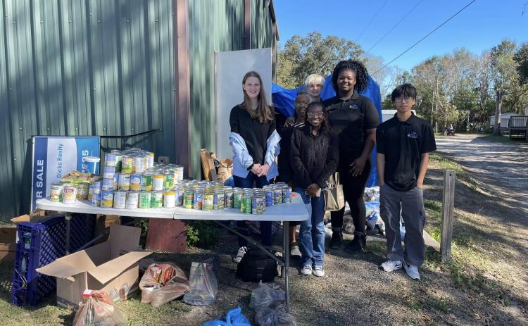 Students with the Columbia High FBLA program helped pass out food this past weekend with the Kids Feeding Kids Thanksgiving program. (COURTESY)