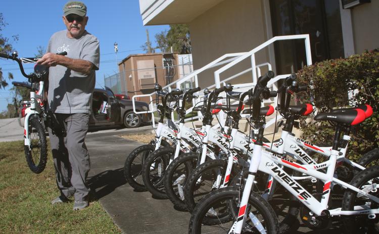 Mike Kelley, the vice president of the Suwannee Bike Association, lines up bicycles that the group donated to the Columbia County Toys for Tots program last week. The bicycle group has contributed to Toys for Tots for three years. (TONY BRITT/Lake City Reporter)