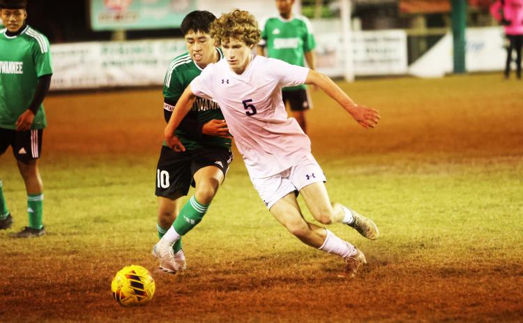 Columbia’s Nathan Matsubara (5) dribbles past Suwannee’s Denzel Yaxon (10) during Monday’s match. (PAUL BUCHANAN/Lake City Reporter)