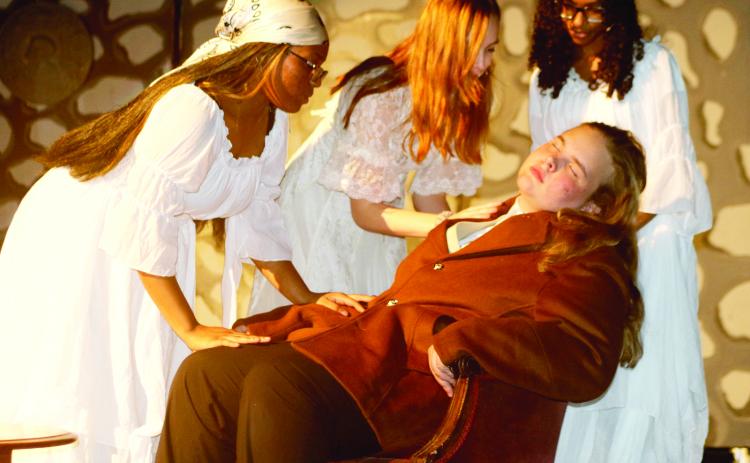 Tikeria Bryant (from left), Marion ‘Ash’ Wolff, and Emoniee Taylor portray female vampires competing for Elijah Merritt’s blood during the Columbia High theatre’s rehearsal for Bram Stoker’s ‘Dracula.’ (TONY BRITT/Lake City Reporter)