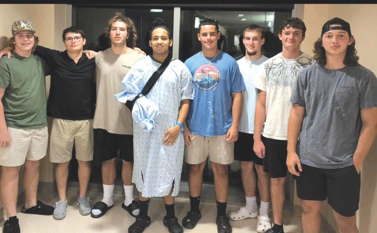 Davic Kasper (middle) was involved in a side-by-side ATV crash back in August, necessitating the amputation of his right hand. A set of fundraisers are being organized to help cover Kasper’s medical costs. (COURTESY)
