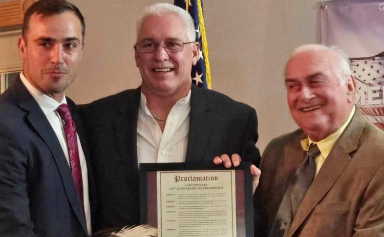 Lake City Elks Lodge 893 members Noah Walker (from left), Exalted Ruler Bill Roberts and Stephen Witt show off a proclamation declaring Nov. 9, 2024, as Lake City Elks Lodge 893 Anniversary Celebration Day. The lodge held a celebration on Saturday night acknowledging 120 years of providing service to Columbia County. (COURTESY)