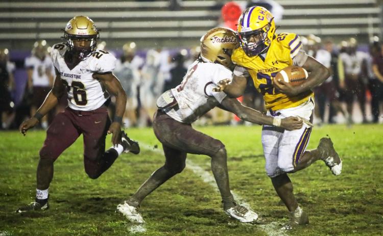 Columbia running back Jerome Horne fights through a tackle from St. Augustine defensive back Braylon James on Sept. 25. (BRENT KUYKENDALL/Lake City Reporter)