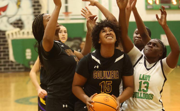 Columbia forward Jolena Gardner grabs a rebound in traffic during Friday’s game against Suwannee. (PAUL BUCHANAN/Lake City Reporter)