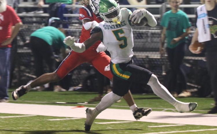 Suwannee receiver MJ Rossin evades a Wakulla defender on his way to the end zone for a touchdown in the first quarter of Thursday’s game. (MORGAN MCMULLEN/Lake City Reporter)