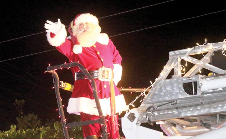 Santa Claus waves to spectators during last year’s Rotary Club of Lake City Christmas parade. (FILE)