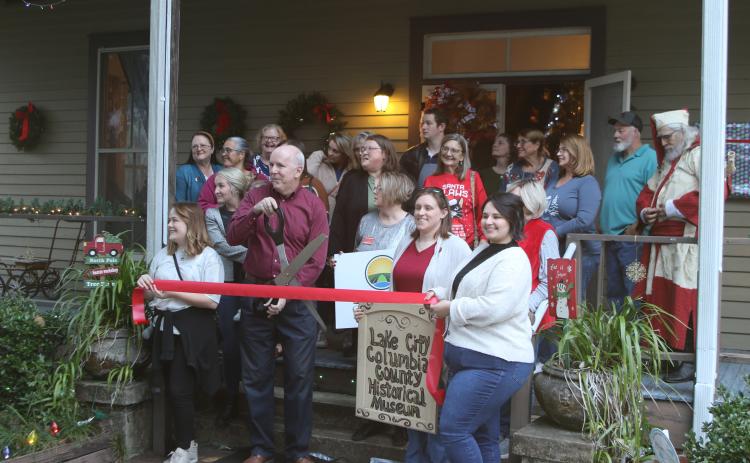 Members of the Lake City-Columbia County Historical Museum prep to cut the ribbon during the museum’s grand re-opening event Thursday. (TONY BRITT/Lake City Reporter)