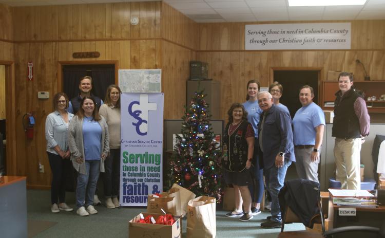 The Christian Service Center and volunteers from Gallagher Insurance provided food to nearly 200 people as part of the agency’s annual Christmas Basket distribution. (TONY BRITT/Lake City Reporter)