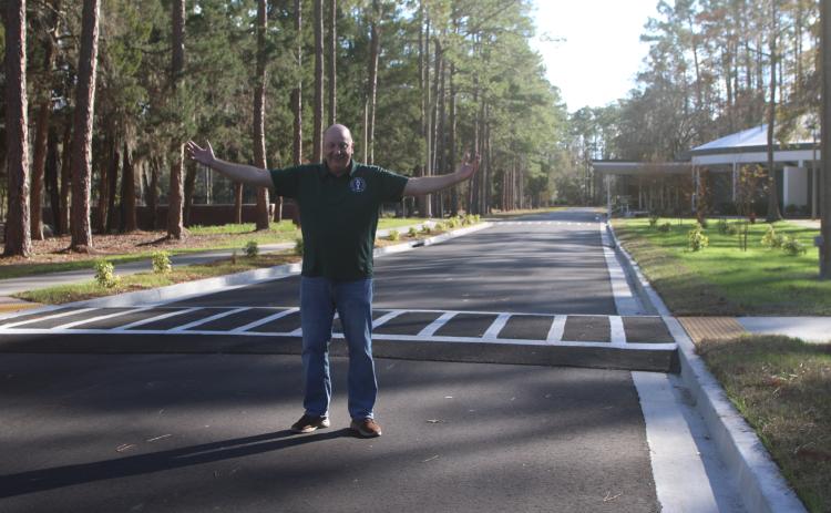 Florida Gateway College President Larry Barrett stands on the finished roadway on the college campus that runs past the Howard Center. The road was opened a few weeks ago. (TONY BRITT/Lake City Reporter)