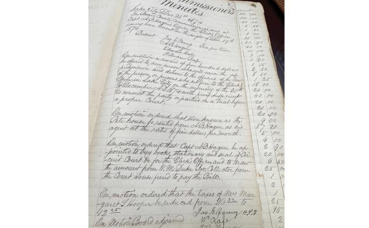 Minutes from the Dec. 21, 1874, Columbia County Commission meeting show the county offered a $5,000 reward for the capture and conviction of whoever burned down the courthouse the previeous day. Nobody was ever charged with the crime. (JAMIE WACHTER/Lake City Reporter)