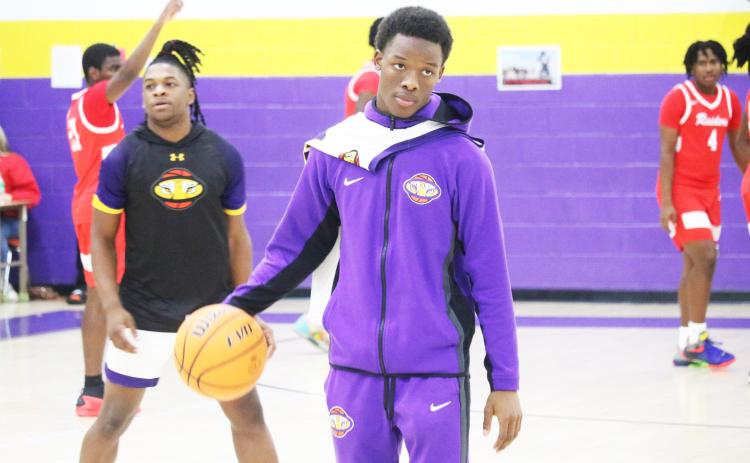 Columbia guard Marlin Haywood helps the Tigers warm up prior to Friday’s game against Santa Fe. Haywood has transferred back to Columbia after playing football at Bradford this fall. (JORDAN KROEGER/Lake City Reporter)