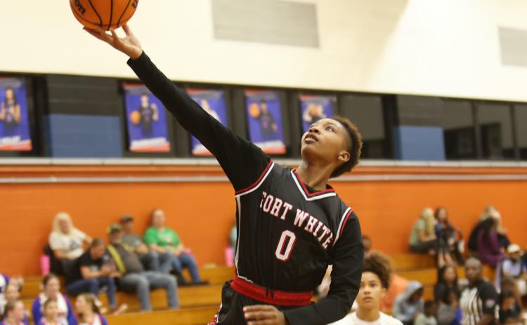 Fort White forward Isreal Hart makes a layup against Branford on Tuesday night. (PAUL BUCHANAN/Lake City Reporter)